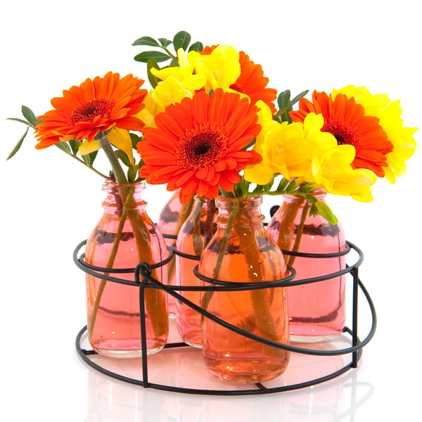 Rack with flowers in bottles — Stock Photo, Image