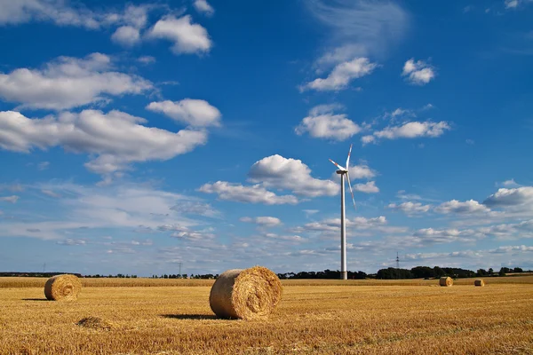 Bales of straw and a windmill — Stock Photo, Image