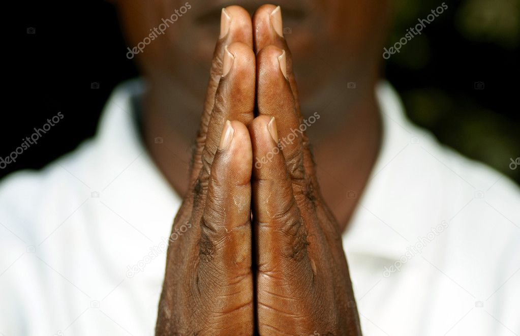 Fingers of afro man in prayer