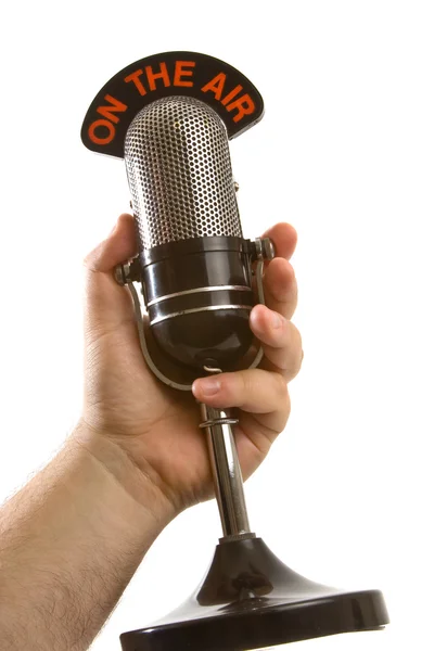 Microfone na mão sobre branco — Fotografia de Stock