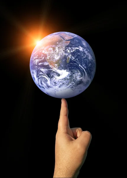 stock image The Earth Balancing on a Finger