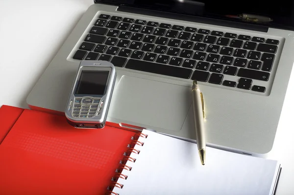 Phone, laptop and empty notebook on the desk — Stock Photo, Image