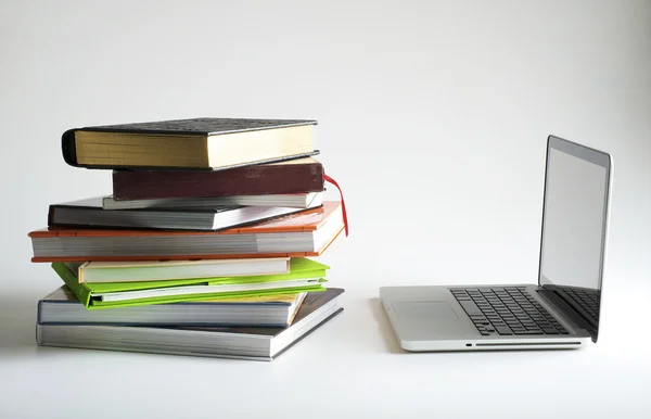 stock image Stack of book and laptop