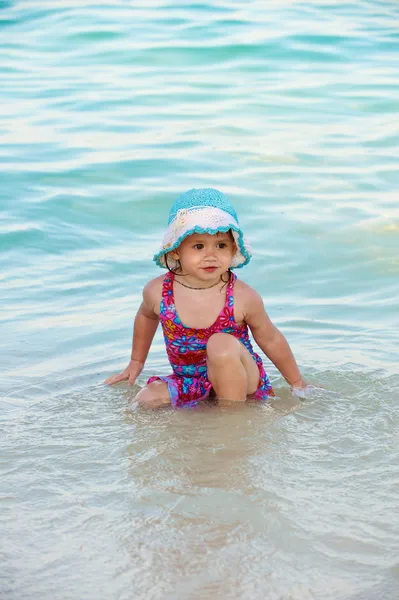 stock image The littel girl plays in water