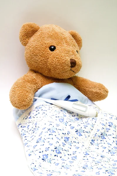 Teddy bear with a thermometer Stock Photo