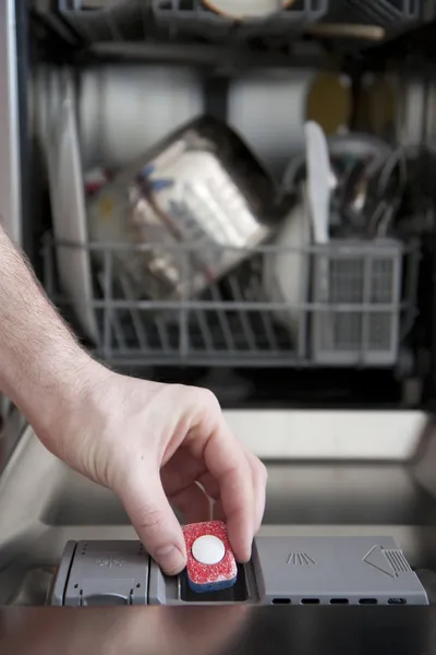 Putting tab into dishwasher — Stock Photo, Image