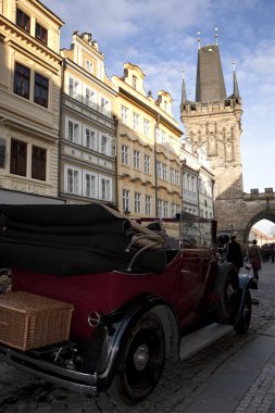 Veteran car and tower in Prague clipart