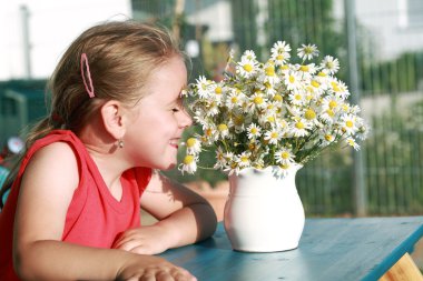 Little girl with chamomile clipart