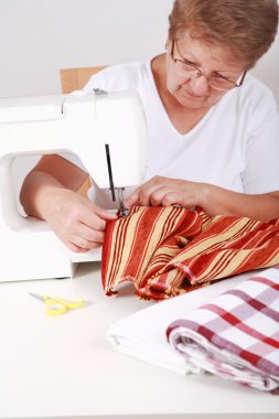 Elderly woman sewing clipart