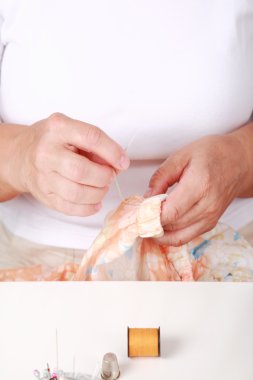 Elderly woman sewing clipart