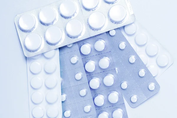Pillole come sfondo in tono blu — Foto Stock