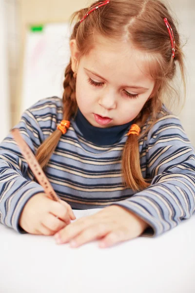 Cute little girl painting at home — Stock Photo, Image