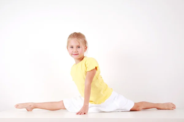 Little girl stretching Stock Photo by ©nyavro 106222846