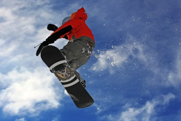 Snowboarder che salta in alto nell'aria Immagini Stock Royalty Free