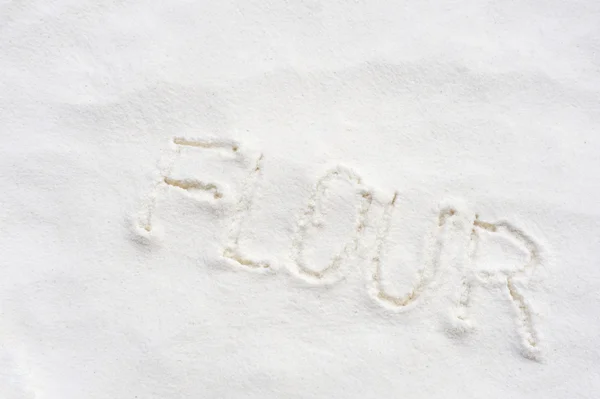 Word flour handwritten in flour — Stock Photo, Image