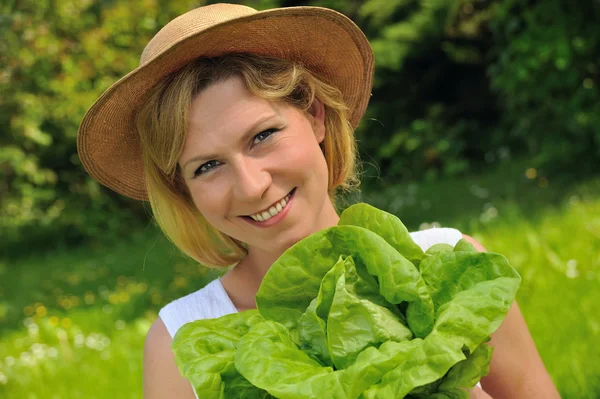 Young woman holding fresh lettuce — Stock Photo, Image