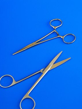 Surgical tools over blue background clipart