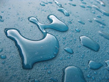 Water drops over blue plastic material clipart
