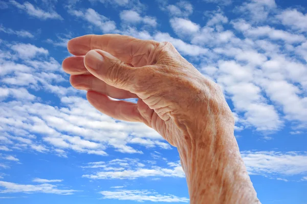 Mujer mayor - mano sobre el cielo —  Fotos de Stock