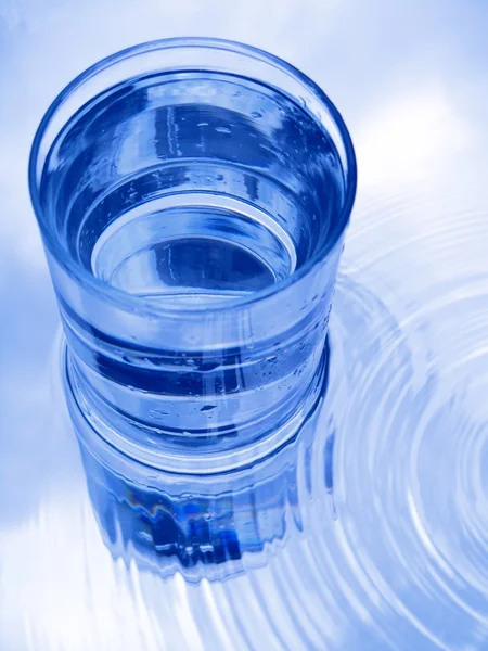 Glass of water in blue — Stock Photo, Image