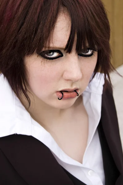 stock image Woman with eyeliner and lip piercings