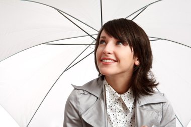 Smiling girl with an umbrella clipart