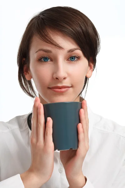 Beautiful young woman with mug in hands — Stock Photo, Image