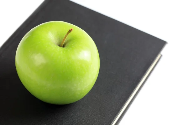 Green apple on book — Stock Photo, Image
