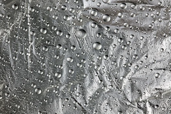 Water drops on silver — Stock Photo, Image