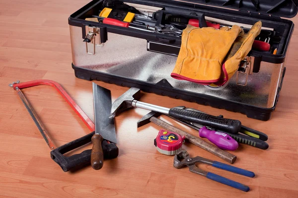Tools in tool box on wooden floor — Stock Photo, Image