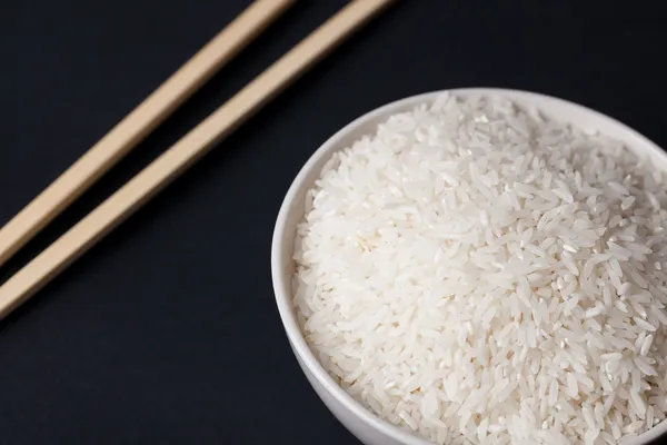 White rice in bowl and chopsticks — Stock Photo, Image