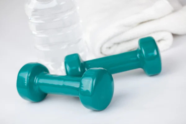 Dumbells with towel and water — Stock Photo, Image