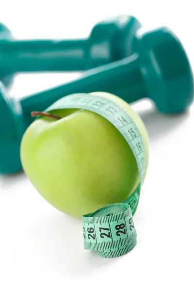 Green apple with measuring tape — Stock Photo, Image