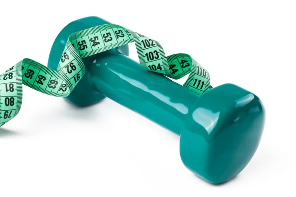 Green dumbell with measuring tape — Stock Photo, Image