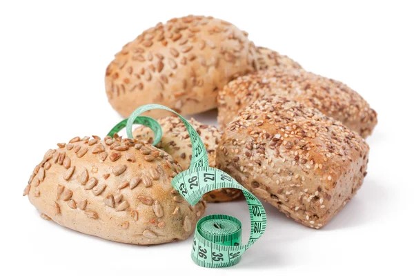 Bread rolls with measuring tape — Stock Photo, Image