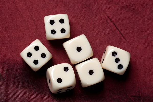 Dice on red fabric — Stock Photo, Image