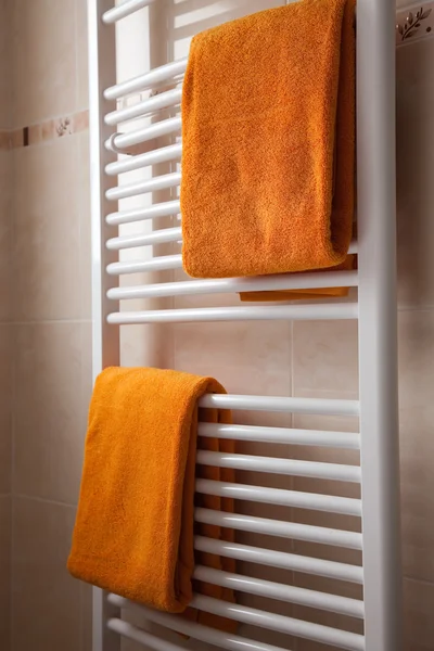 Orange towels on heater — Stock Photo, Image