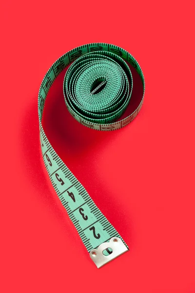 Kırmızı bir arka plan üzerinde ölçüm bandı — Stok fotoğraf
