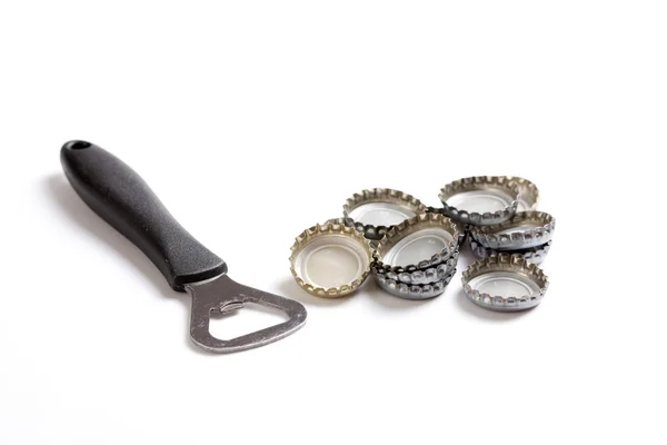 Beer caps and opener — Stock Photo, Image