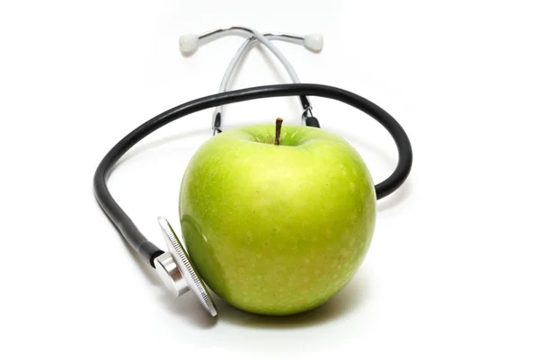 Стетоскоп и яблоко — стоковое фото