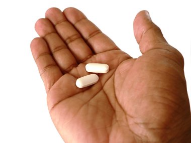 Aspirin in open hand 2 clipart