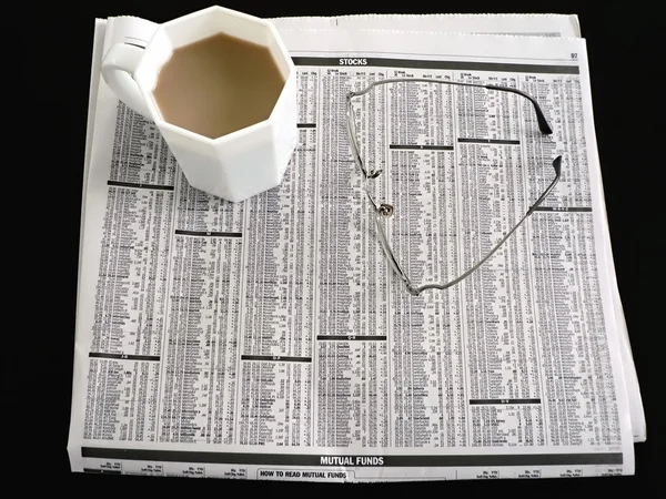 Newspaper - stocks, coffee, eyeglasses 3 — Stock Photo, Image