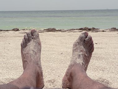 Beach - feet lounging in the sand clipart