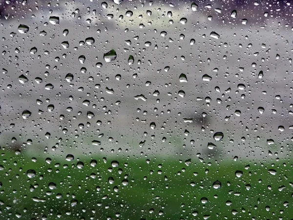 Raindrops on vehicle window — Stock Photo, Image