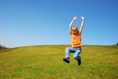 Boy jumping in nature clipart