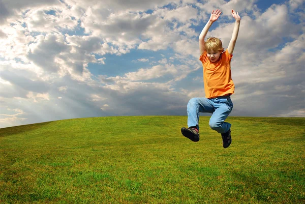stock image Boy jumping on grass