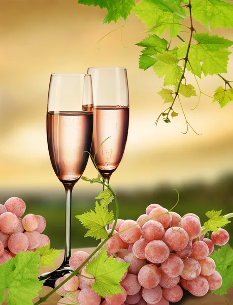 Розовое шампанское и виноград — стоковое фото