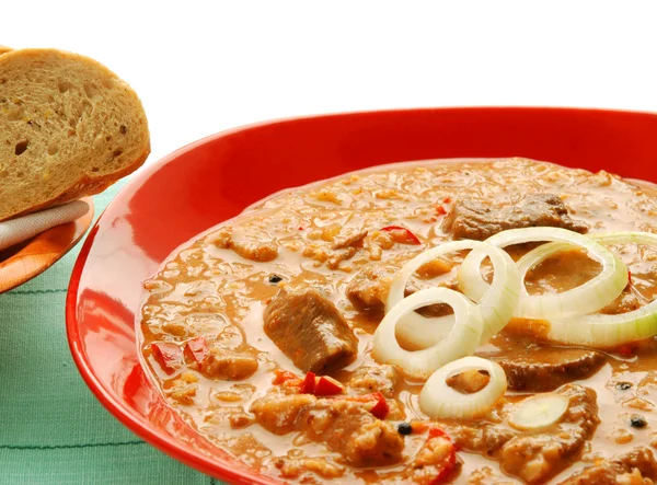 Goulash on red plate in detail — Stock Photo, Image