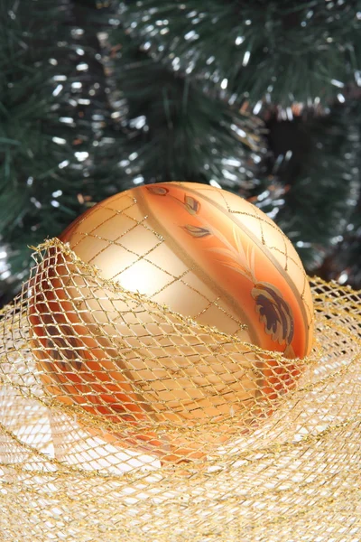 Golden bauble with golden ribbon — Stock Photo, Image