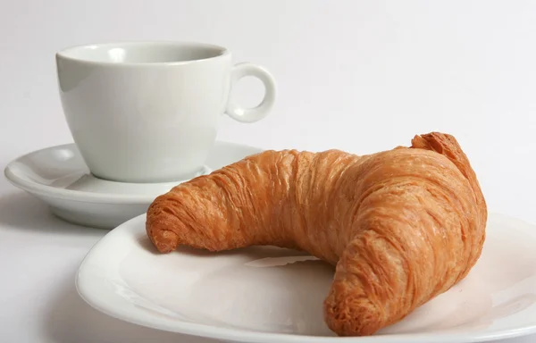 White cup and croissant on plate — Stock Photo, Image
